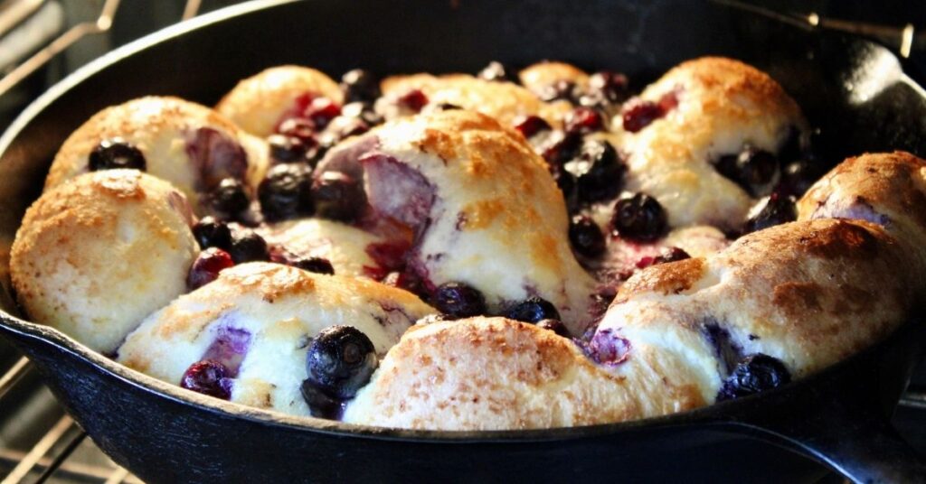 Blueberry Dutch baby puffed up in the oven